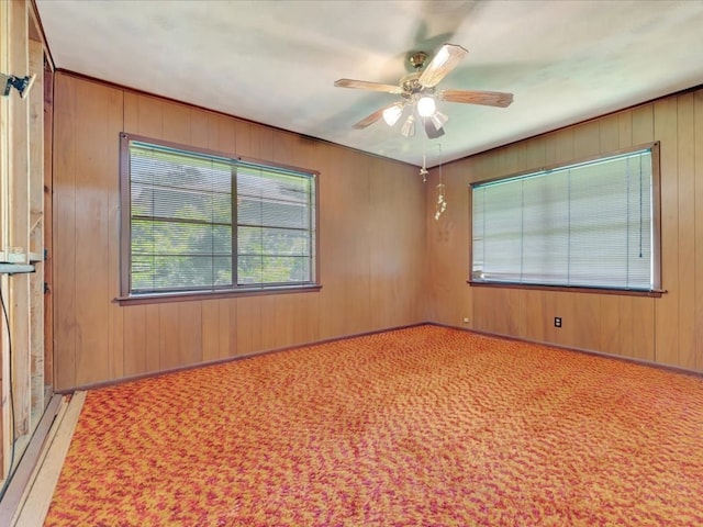 602 Devereaux, Diboll, TX 75941 - carpeted empty room featuring ceiling fan and wood walls