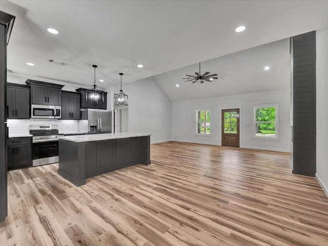 1920 Fm 842, Lufkin, TX 75901 - kitchen featuring stainless steel appliances, light wood-style flooring, recessed lighting, a center island, and lofted ceiling