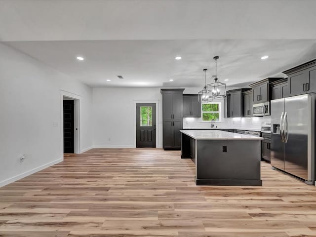 1920 Fm 842, Lufkin, TX 75901 - kitchen with stainless steel appliances, light wood-type flooring, a center island, light countertops, and recessed lighting