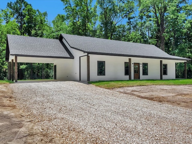 1920 Fm 842, Lufkin, TX 75901 - view of front of home with roof with shingles, gravel driveway, and a carport