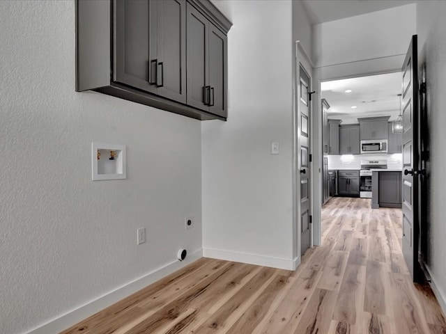 1920 Fm 842, Lufkin, TX 75901 - laundry area featuring cabinet space, electric dryer hookup, light wood-style flooring, washer hookup, and recessed lighting