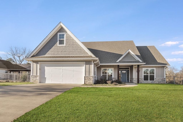 craftsman-style home with stone siding, a front lawn, concrete driveway, and fence