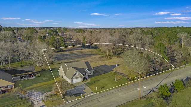 birds eye view of property featuring a wooded view