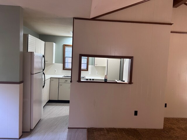 kitchen featuring freestanding refrigerator