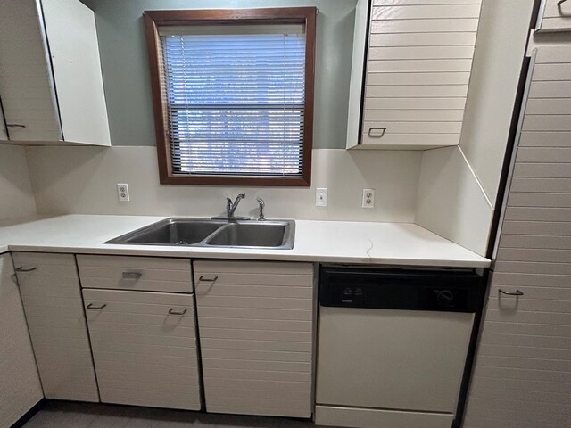 kitchen with white cabinets, dishwasher, light countertops, gray cabinetry, and a sink