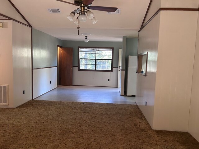 empty room with light carpet, ceiling fan, and visible vents