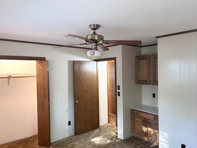 unfurnished bedroom with a ceiling fan and crown molding