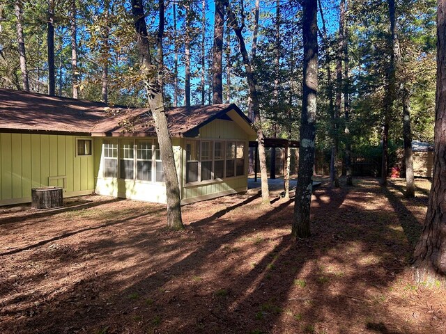 exterior space featuring central AC and a sunroom