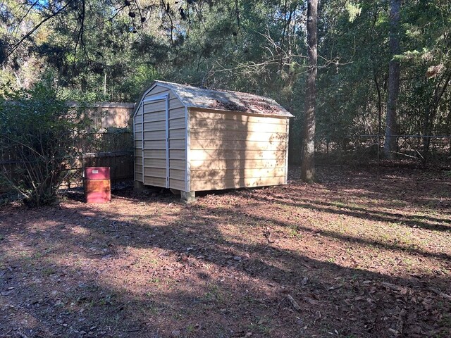 view of shed with fence