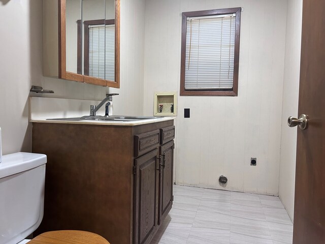 half bath featuring toilet and vanity