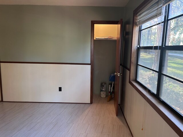 spare room featuring wainscoting