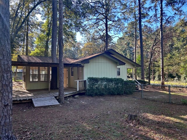 view of property exterior featuring fence and a wooden deck