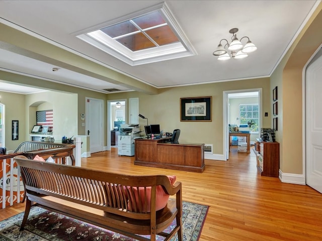107 W Kerr Ave, Lufkin, TX 74904 - office area with a skylight, light wood finished floors, a chandelier, arched walkways, and crown molding
