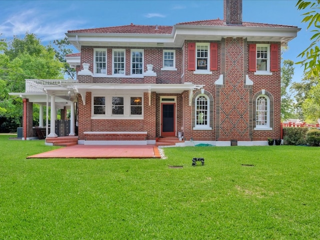 107 W Kerr Ave, Lufkin, TX 74904 - view of front of home featuring a chimney, a front lawn, brick siding, and entry steps
