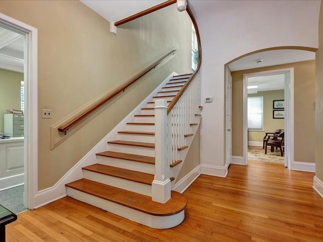 107 W Kerr Ave, Lufkin, TX 74904 - staircase featuring wood finished floors, plenty of natural light, and arched walkways
