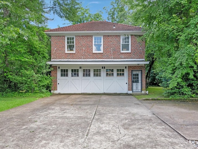 107 W Kerr Ave, Lufkin, TX 74904 - view of front of home featuring brick siding, driveway, and a tiled roof
