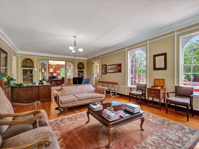 107 W Kerr Ave, Lufkin, TX 74904 - living room with a chandelier, ornamental molding, and light wood-type flooring