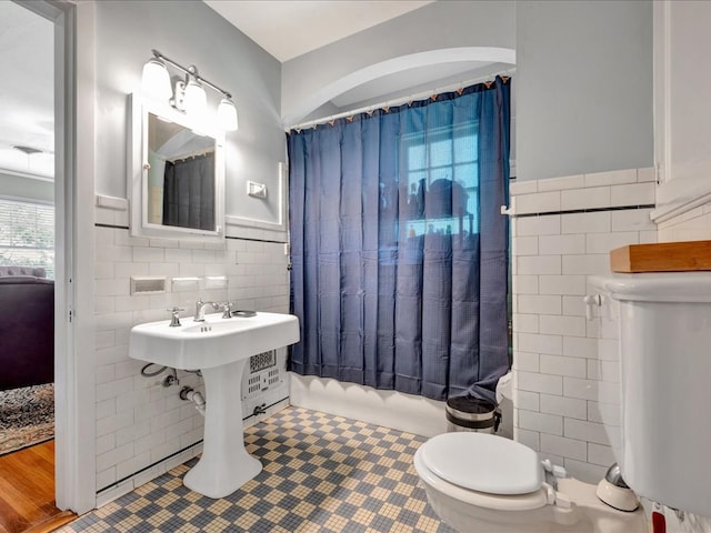 107 W Kerr Ave, Lufkin, TX 74904 - full bath with tile walls, shower / bath combo, tile patterned floors, and wainscoting