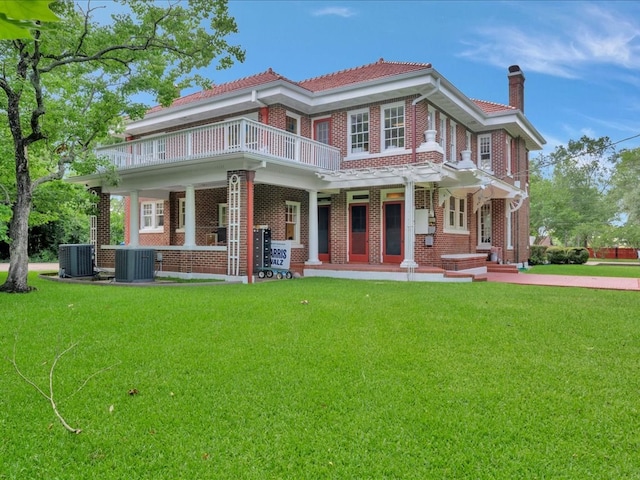107 W Kerr Ave, Lufkin, TX 74904 - view of front facade featuring a balcony, brick siding, a front yard, and a chimney