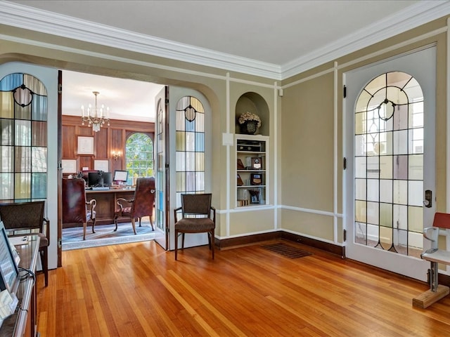 107 W Kerr Ave, Lufkin, TX 74904 - entrance foyer featuring wood finished floors, a chandelier, and crown molding
