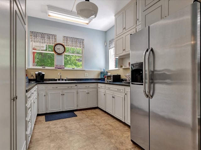 107 W Kerr Ave, Lufkin, TX 74904 - kitchen with stainless steel refrigerator with ice dispenser and dark countertops