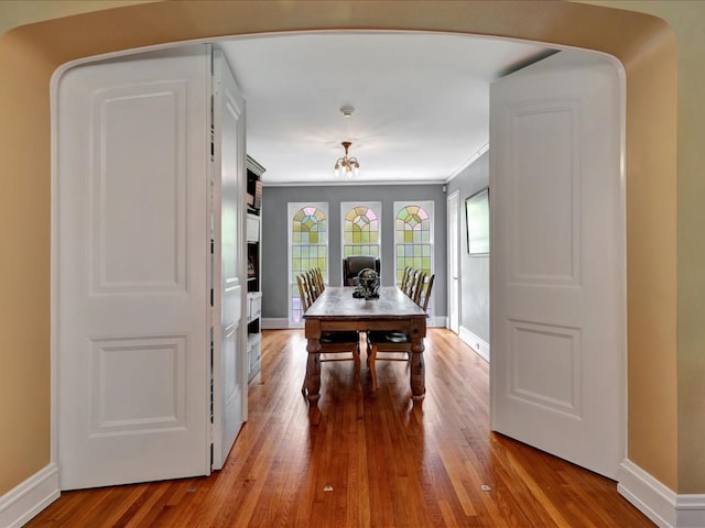 107 W Kerr Ave, Lufkin, TX 74904 - dining space featuring wood finished floors, arched walkways, and ornamental molding