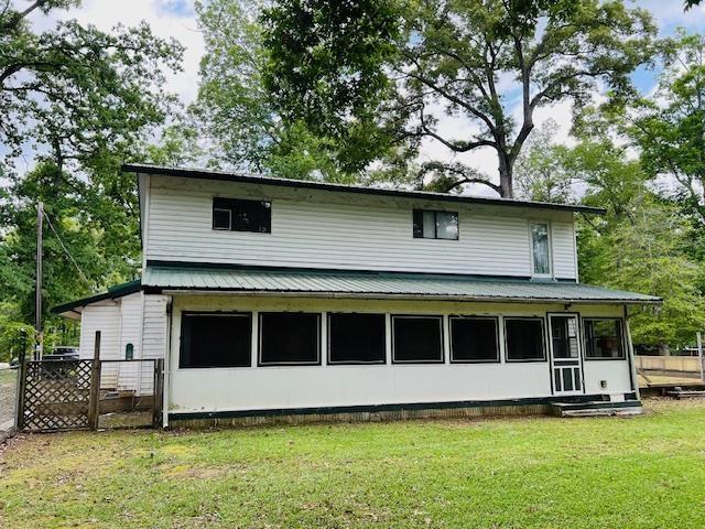 back of house with a yard