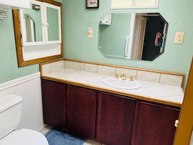 bathroom featuring vanity and toilet