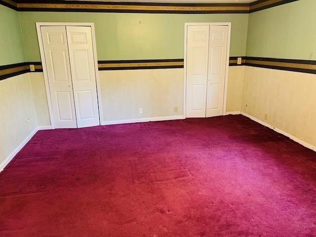 unfurnished bedroom with carpet and ornamental molding