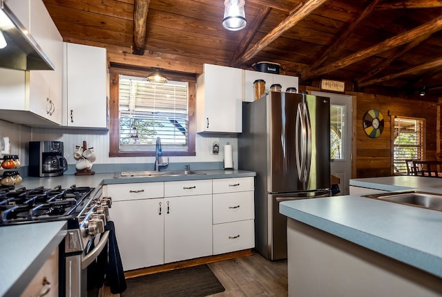kitchen featuring a sink, wood ceiling, a healthy amount of sunlight, stainless steel appliances, and under cabinet range hood