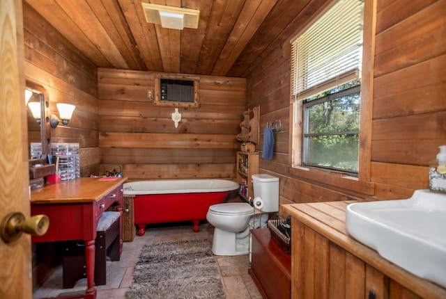 full bathroom featuring a soaking tub, wooden ceiling, wooden walls, and a sink