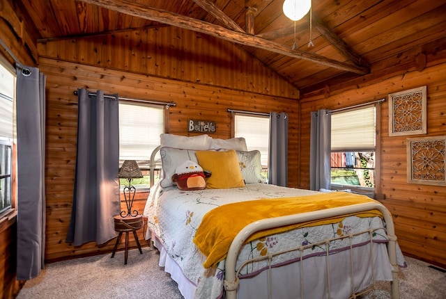carpeted bedroom with vaulted ceiling with beams, wooden ceiling, multiple windows, and wood walls
