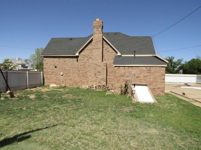 rear view of house with a lawn