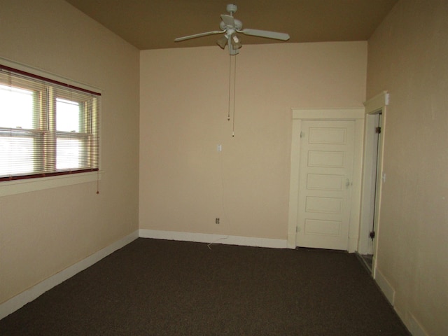 carpeted spare room featuring ceiling fan