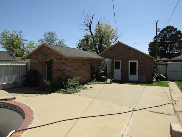 rear view of property with a patio area and an outdoor structure