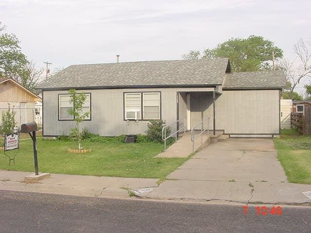 ranch-style house with cooling unit and a front lawn