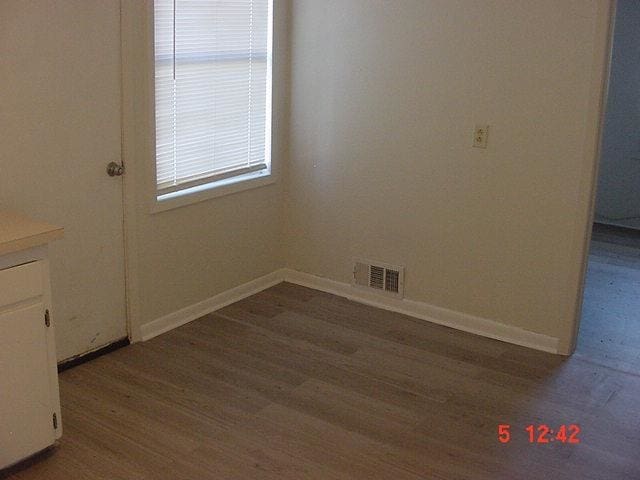 unfurnished room featuring dark wood-type flooring