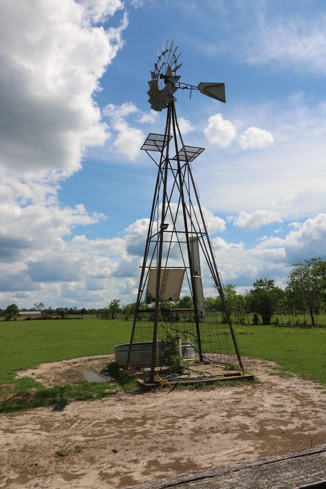 view of playground featuring a yard and a rural view