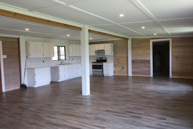 unfurnished living room with wood walls and dark hardwood / wood-style flooring