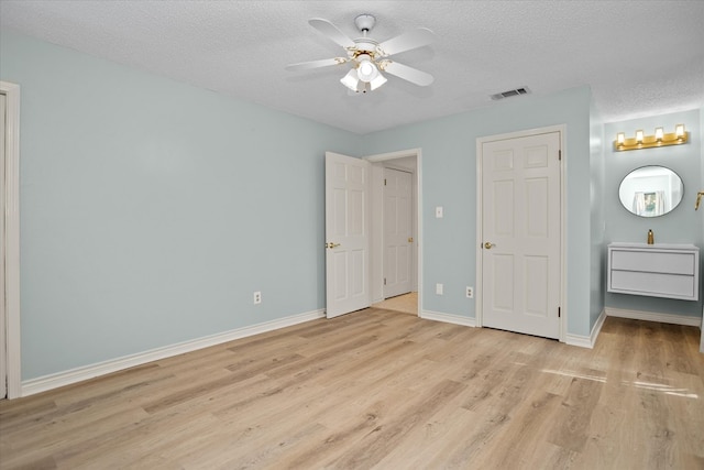 109 Innisbrook Dr, Lufkin, TX 75901 - unfurnished bedroom featuring light wood finished floors, a textured ceiling, baseboards, and a ceiling fan