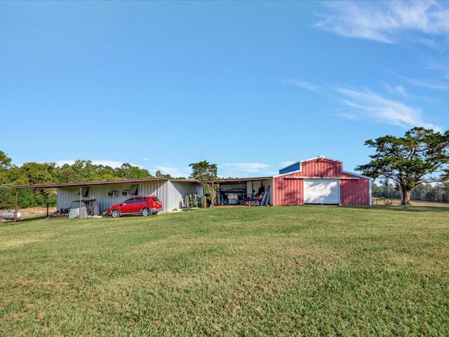 128 Tamie Lowe Rd, Moscow, TX 75960 - view of grassy yard with an outbuilding and a detached garage
