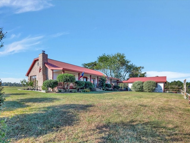 128 Tamie Lowe Rd, Moscow, TX 75960 - view of side of home with a chimney, metal roof, and a lawn
