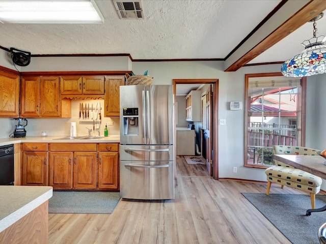 128 Tamie Lowe Rd, Moscow, TX 75960 - kitchen featuring stainless steel fridge, a sink, light countertops, brown cabinets, and crown molding