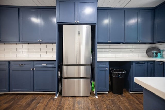 213 Lee Ln, Lufkin, TX 75904 - kitchen featuring freestanding refrigerator, blue cabinetry, light countertops, and tasteful backsplash