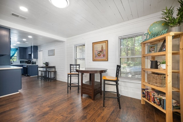 213 Lee Ln, Lufkin, TX 75904 - dining area with plenty of natural light, dark wood-style floors, wooden ceiling, wood walls, and recessed lighting