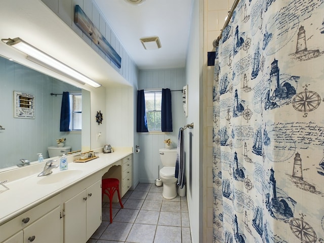 bathroom with tile patterned floors, vanity, toilet, and walk in shower