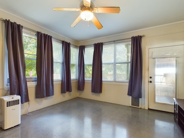 empty room with ceiling fan and crown molding