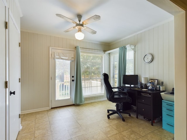 office area featuring ceiling fan, crown molding, and wooden walls