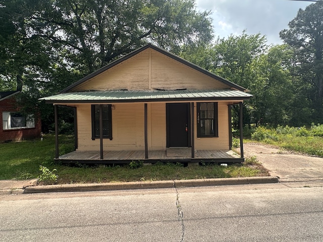 view of front of home featuring a porch and metal roof
