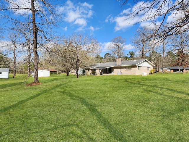 view of yard featuring an outbuilding and a shed